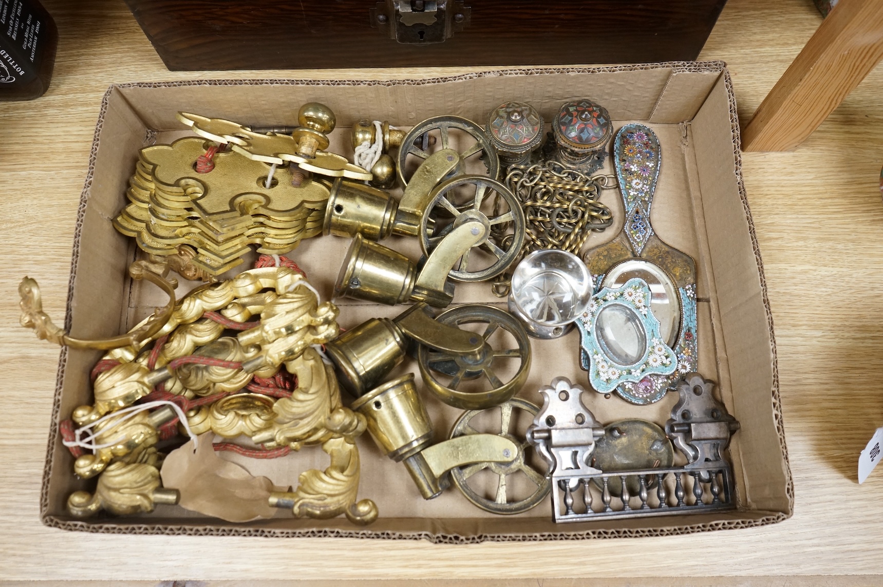 A brush grained tin trunk containing brass furniture mounts and fittings and a micromosaic miniature photo frame and hand mirror, trunk 47cm wide (a.f.)